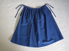 Load image into Gallery viewer, A flat lay of the dark royal blue Europaea skirt, showing the rectangular shape of the skirt, the pleats at the waistband, and the different lengths of the waist ties.
